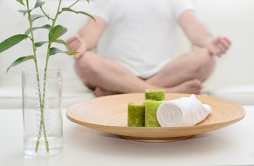 Spa scene with man meditating in white