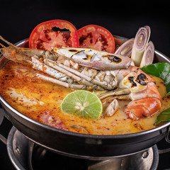 Spicy soup with shrimp in bowl , famous Thai food cuisine calling Tom Yum Kung