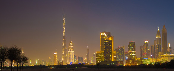 Dubai - The evening skyline of Downtown with the Burj Khalifa and Emirates Towers.