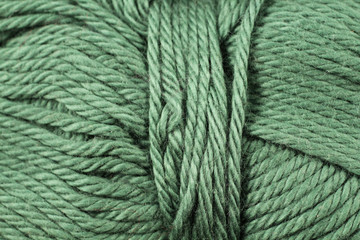 A super close up image of sage green yarn
