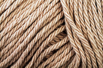 A super close up image of beige yarn