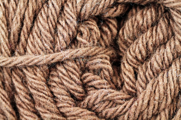 A super close up image of brown yarn