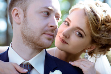 Wedding couple on the nature is hugging each other