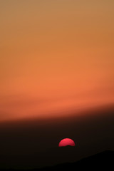 sun behind the mountains at sunset