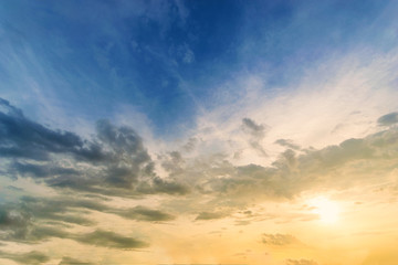 Obraz premium Sky background at sunset,Sky blue and orange light of the sun through the clouds in the sky survive