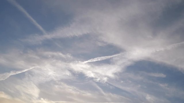 Condensation trails left in the sky by high flying crafts, often mentioned in the chemtrail conspiracy theory.