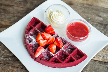 food backgroud -waffle with strawberry sauce on wooden table