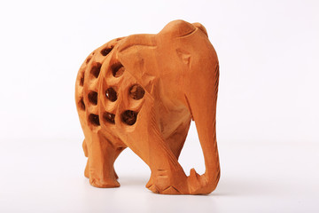 Fototapeta premium Wooden handmade statuette of elephant a white background