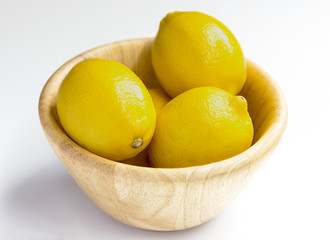 lemon with wooden bowl on white background.