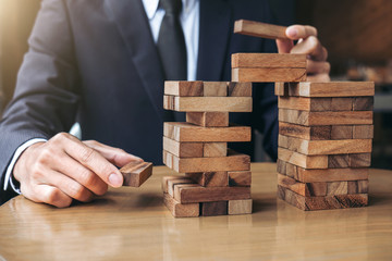 Alternative risk concept, plan and strategy in business, Young intelligent businessman playing the...