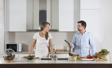 Fototapeta na wymiar couple preparing food in a kitchen