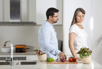 couple preparing food in a kitchen