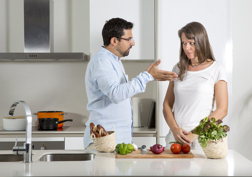 couple preparing food in a kitchen