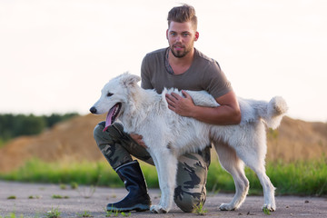 portrait of a man with his white German shepherd