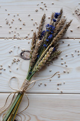 Bouquet of peas of ripe wheat and lavender with grains on a wooden table