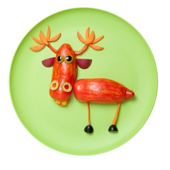 Funny deer made with vegetables on green plate