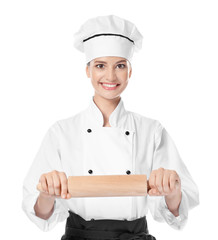 Young female chef with rolling pin on white background
