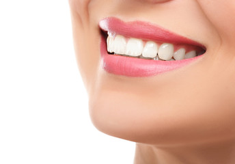 Beautiful young woman with healthy teeth on white background