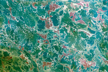 Abstract painting. Marble effect painting on water, called ebru. Mixed purple and blue oil paints. Unusual handmade background for poster, card, invitation, texture.