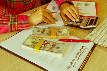 Business woman working with form documents with money