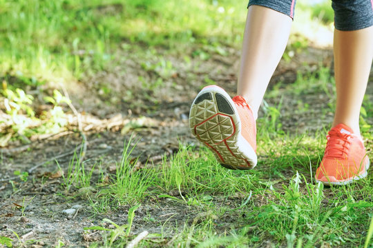 Young Woman In Pink Sneakers Walking Outdoors