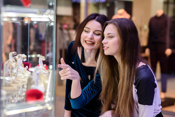 Happy girls smiling and doing shopping in the Mall.