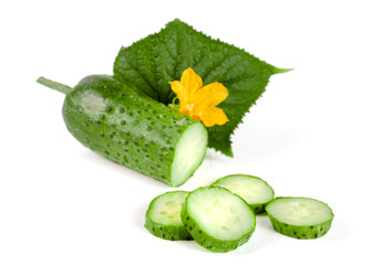 Sliced cucumber with leaf and flower isolated on a white background