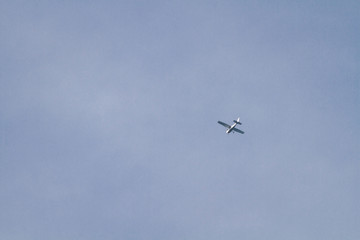 Fototapeta na wymiar Airplane Is Flying / White Airplane Is Flying At Blue Sky Background.