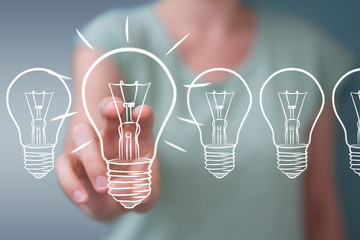 Businesswoman touching and holding a sketch lightbulb with a pen