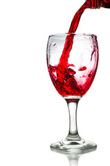 Red wine pouring on a glass isolated on white background. Clipping path
