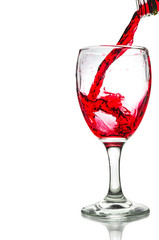 Red wine pouring on a glass isolated on white background. Clipping path