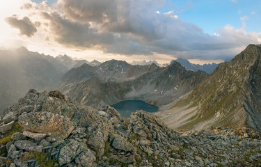 Alpine landscape with mountain lake and mountain peaks