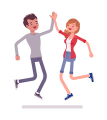 Young man and woman jumping giving high five