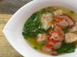 Wonton dumpling asian soup with red pork