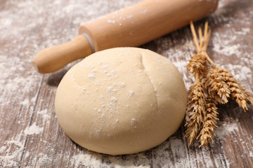raw dough with rolling pin