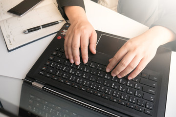Fototapeta na wymiar Businesswoman typing on laptop keyboard in office