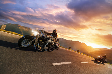 Motorcycle drivers riding in Alpine highway. Outdoor photography, mountain landscape.