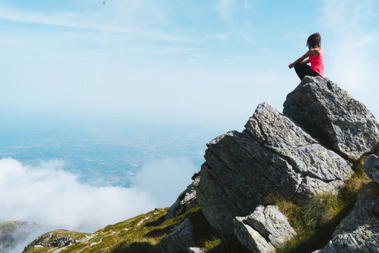 Girl Sitting On A Mountain Rock