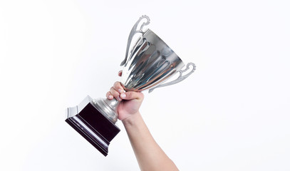 hand holding up a trophy cup as a winner in a competition