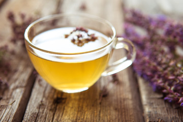 Green tea with herbals. Tea with oregano on the wooden background