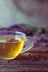 Green tea with herbals. Tea with oregano on the wooden background