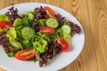 Fresh salad with mixed greens, cherry tomato and cucumber
