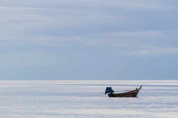 Fototapeta na wymiar fishing boat floating on the sea background