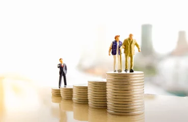 Fotobehang Concept of retirement planning. Miniature people: Old couple figure standing on top of coin stack. © Khongtham