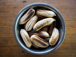 Banana broil in the chalice on wood background