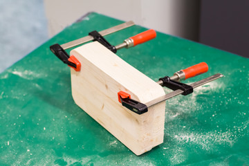 Closeup photo of clamp compression tool in workshop