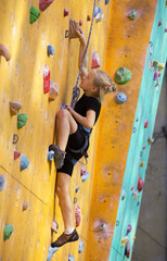  little girl climbing up the wall
