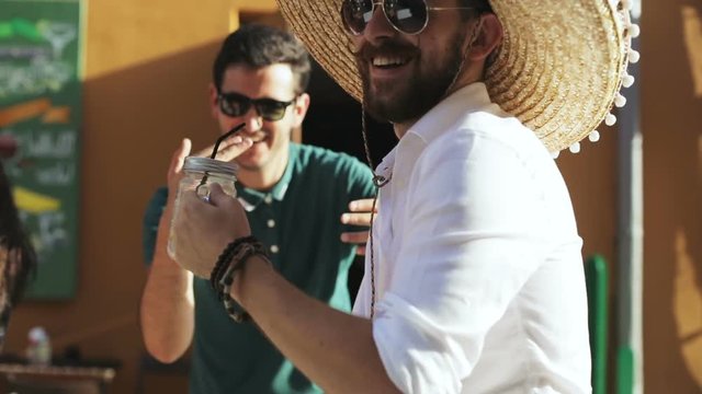 Street carnival fiesta concept - mexican and turkish student it developer programmers guy dancing hard rave at the old city town