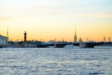 Sunset on the Neva river on the background of the Peter and Paul fortress and Rostral columns