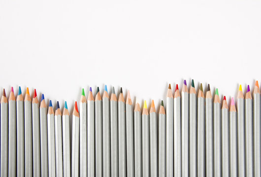Many different color pencils on white background.